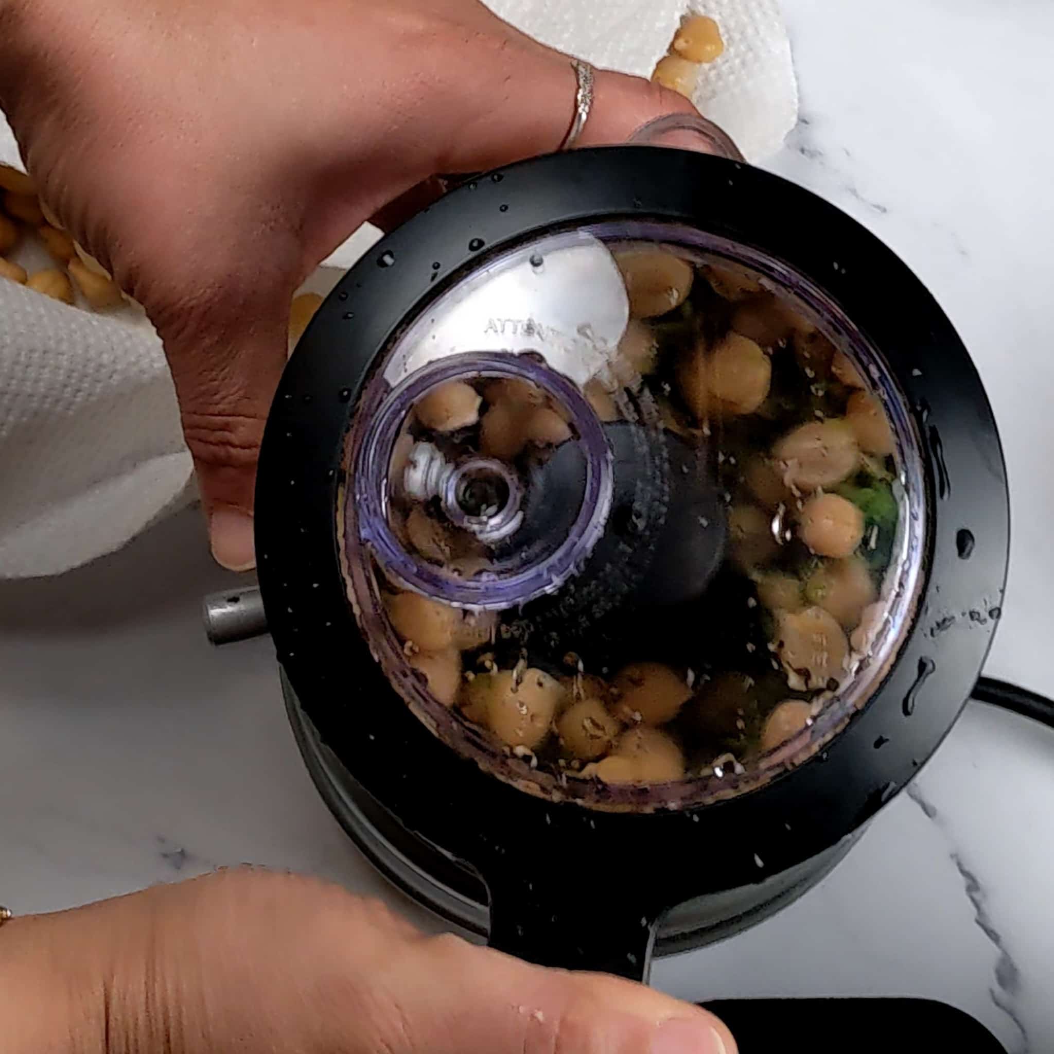 chickpeas in a food processor with the lid on .