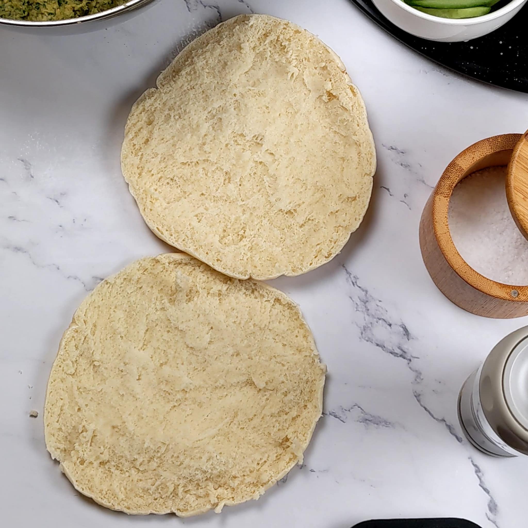 two open faced pita halves laying on the counter.