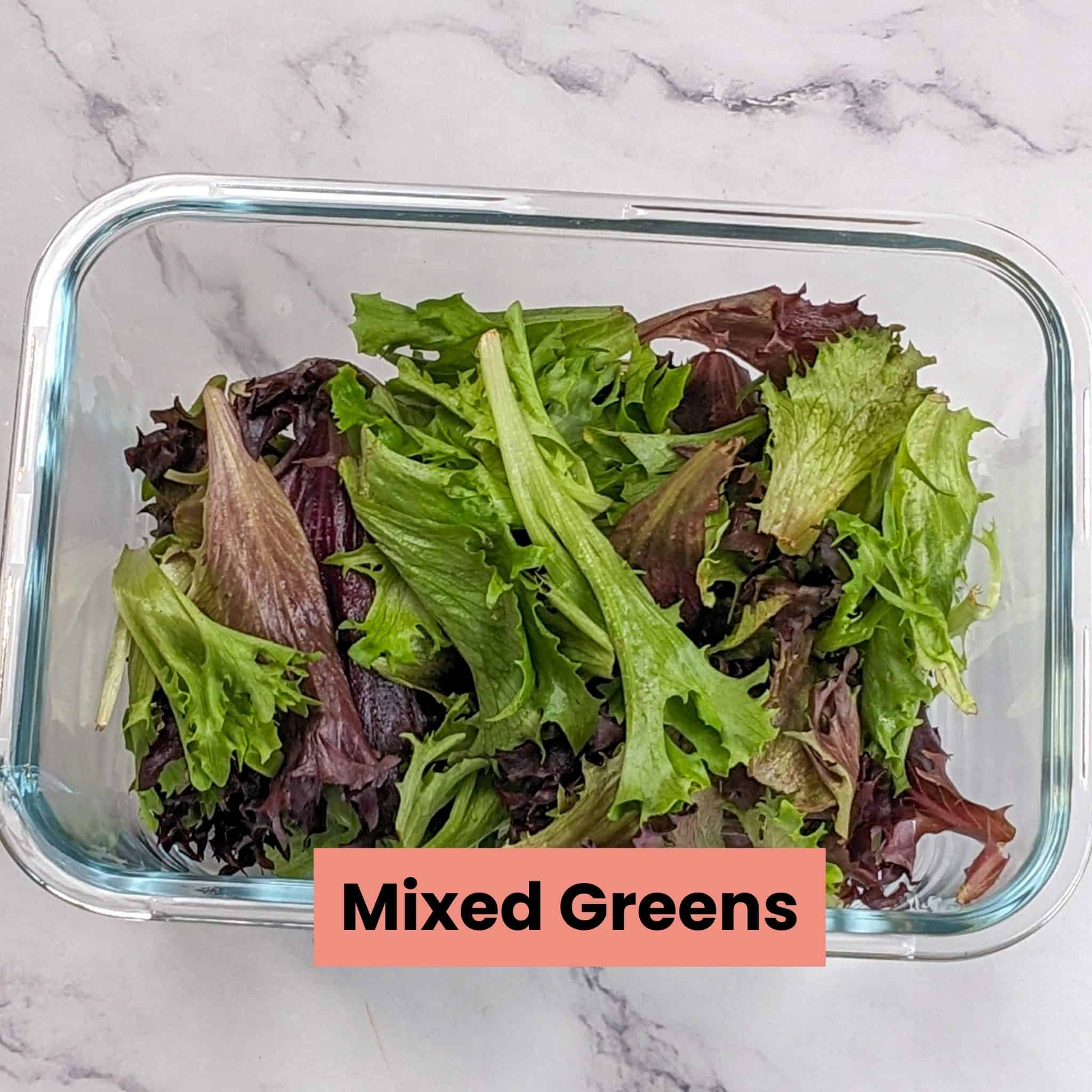 mixed greens in a deep rectangle glass container