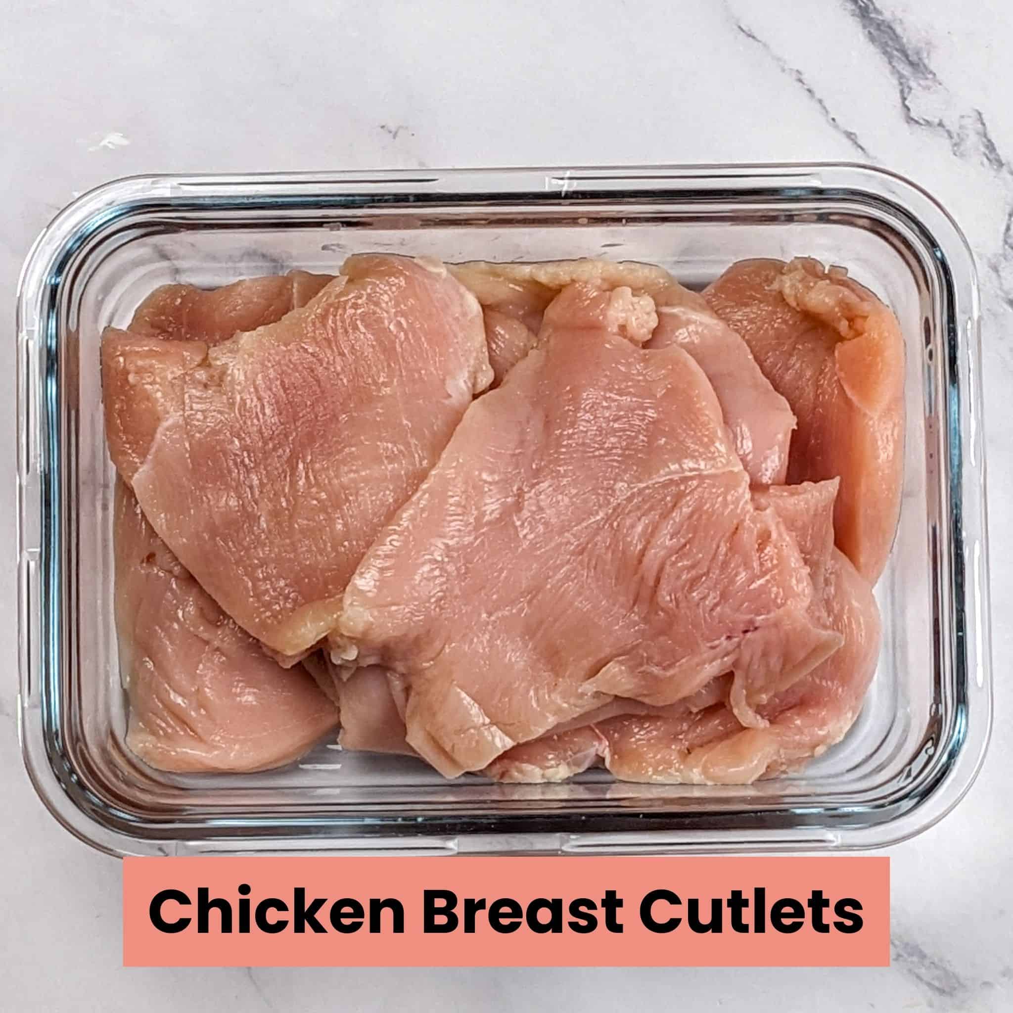 boneless skinless chicken breast cutlets in a shallow glass rectangle container.