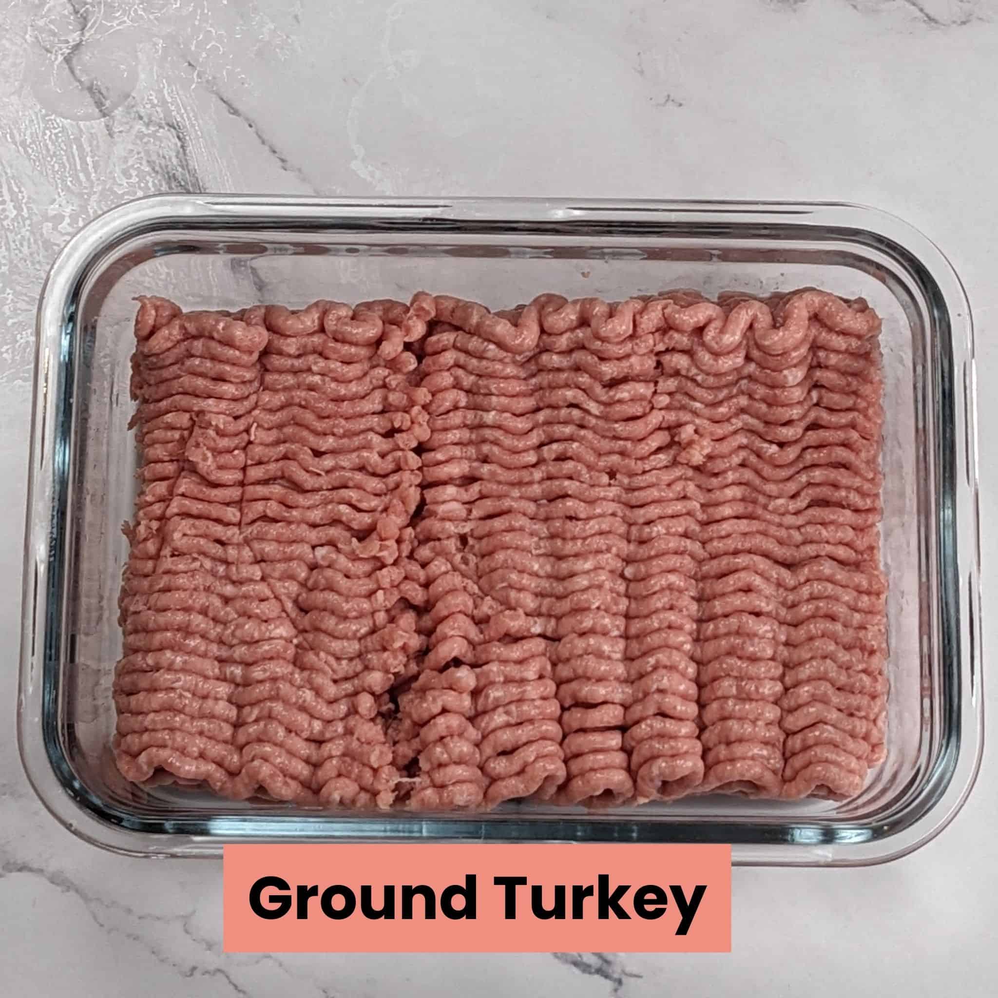 ground turkey in a rectangle glass container.
