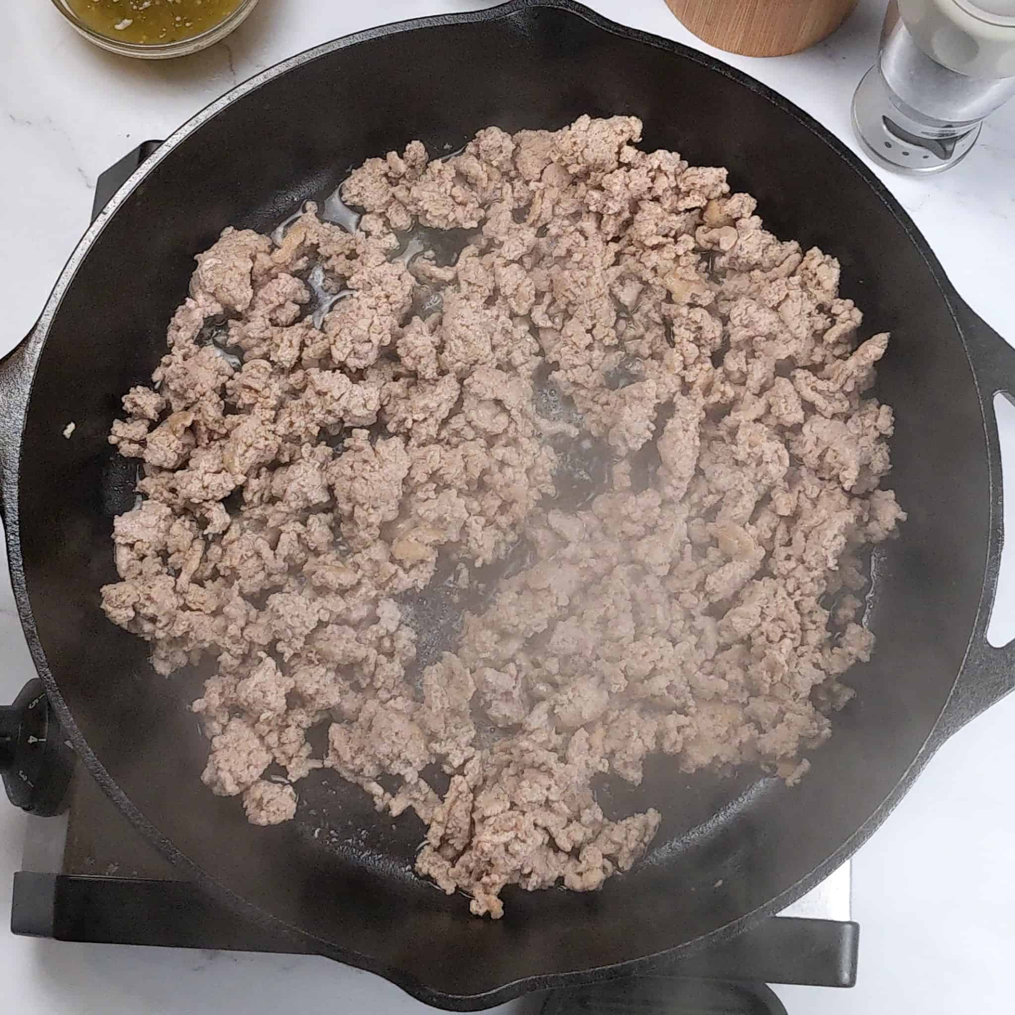 cooked crumbled ground turkey in a cast iron skillet.