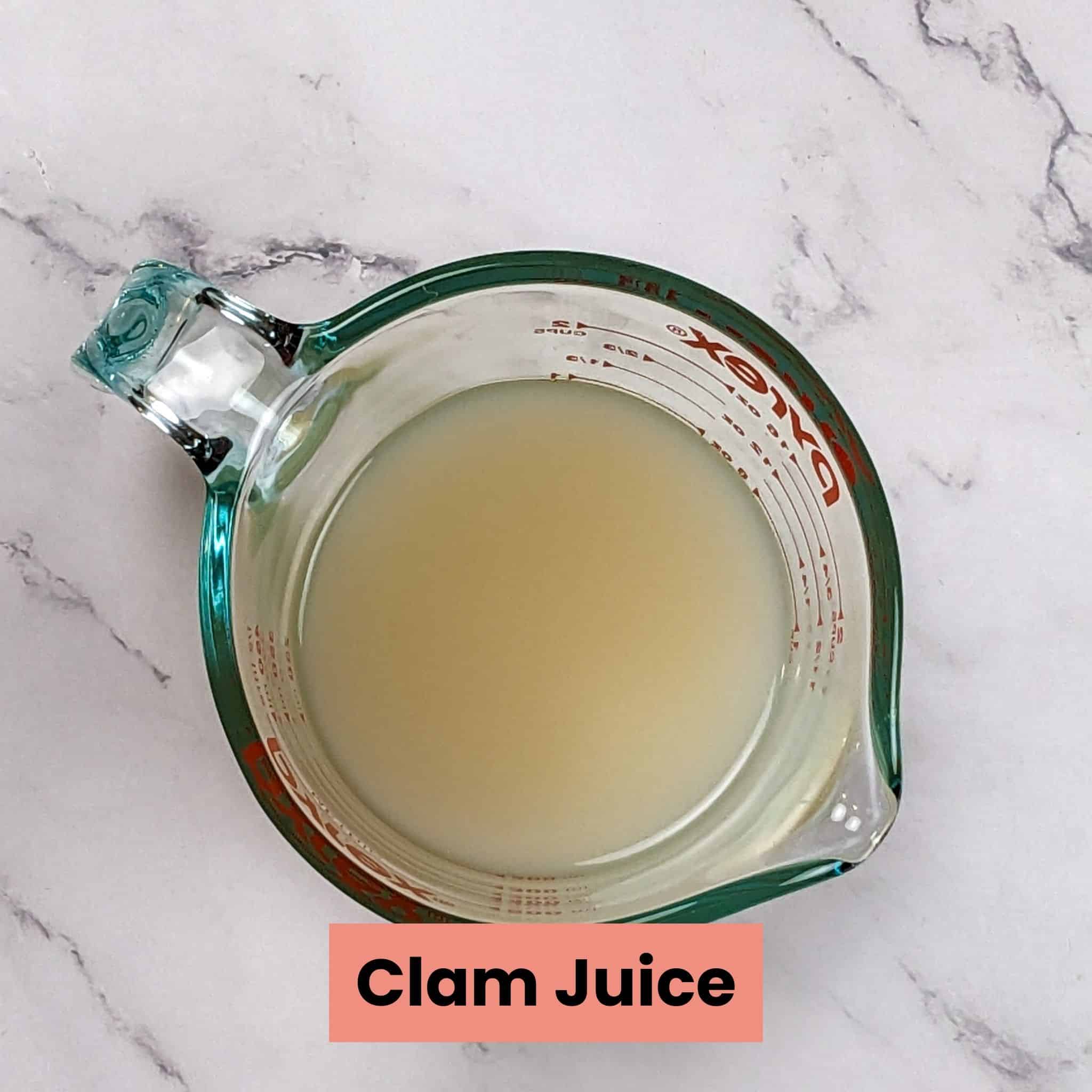 clam juice in a glass pyrex measuring cup.
