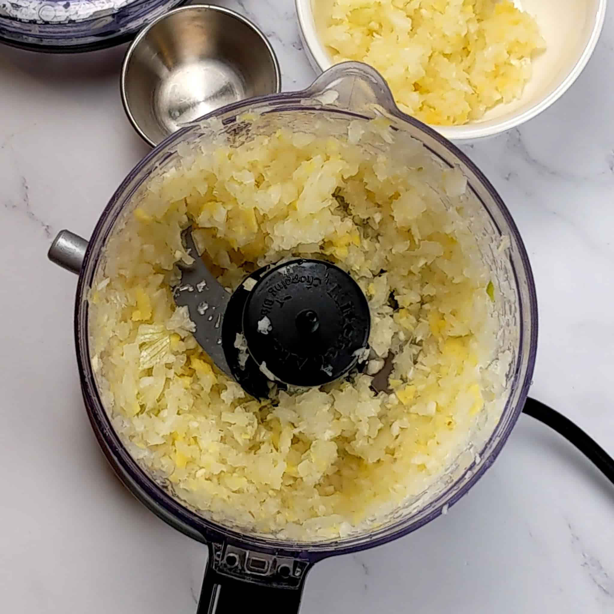 kitchenaid food processor with chopped ginger, garlic and onion.