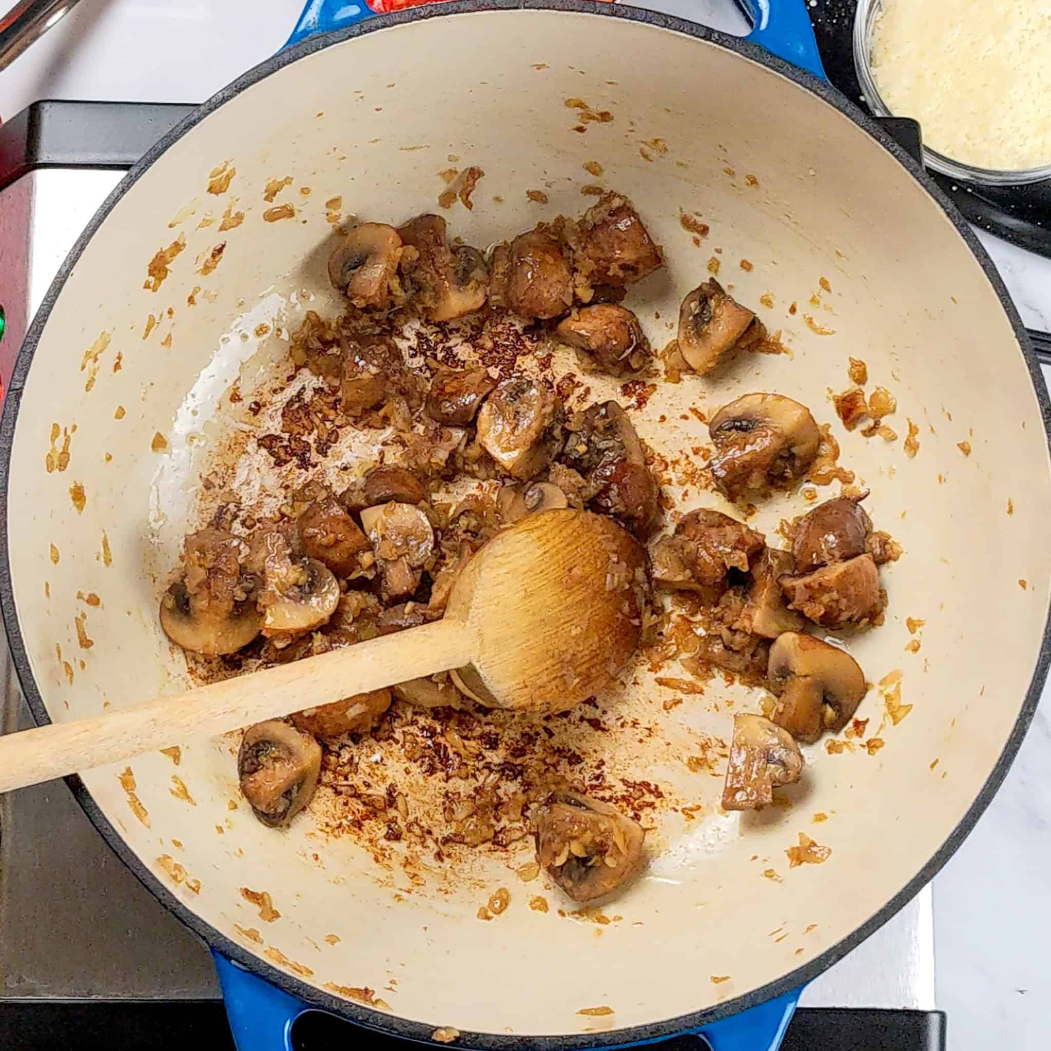 lodge enameled dutch oven with sauted mushrooms.