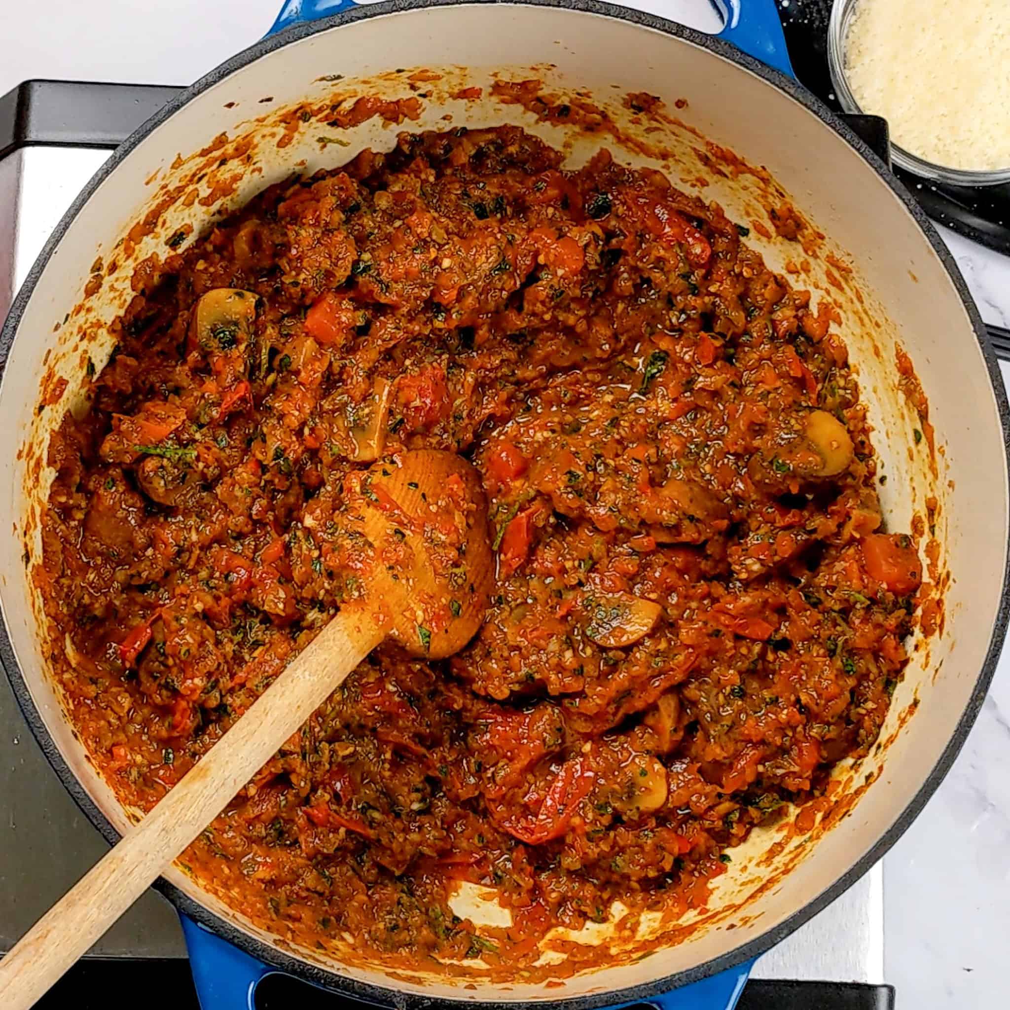 tomato red bell pepper aromatic paste cooked down with tomatoes and mushrooms in a lodge dutch oven.