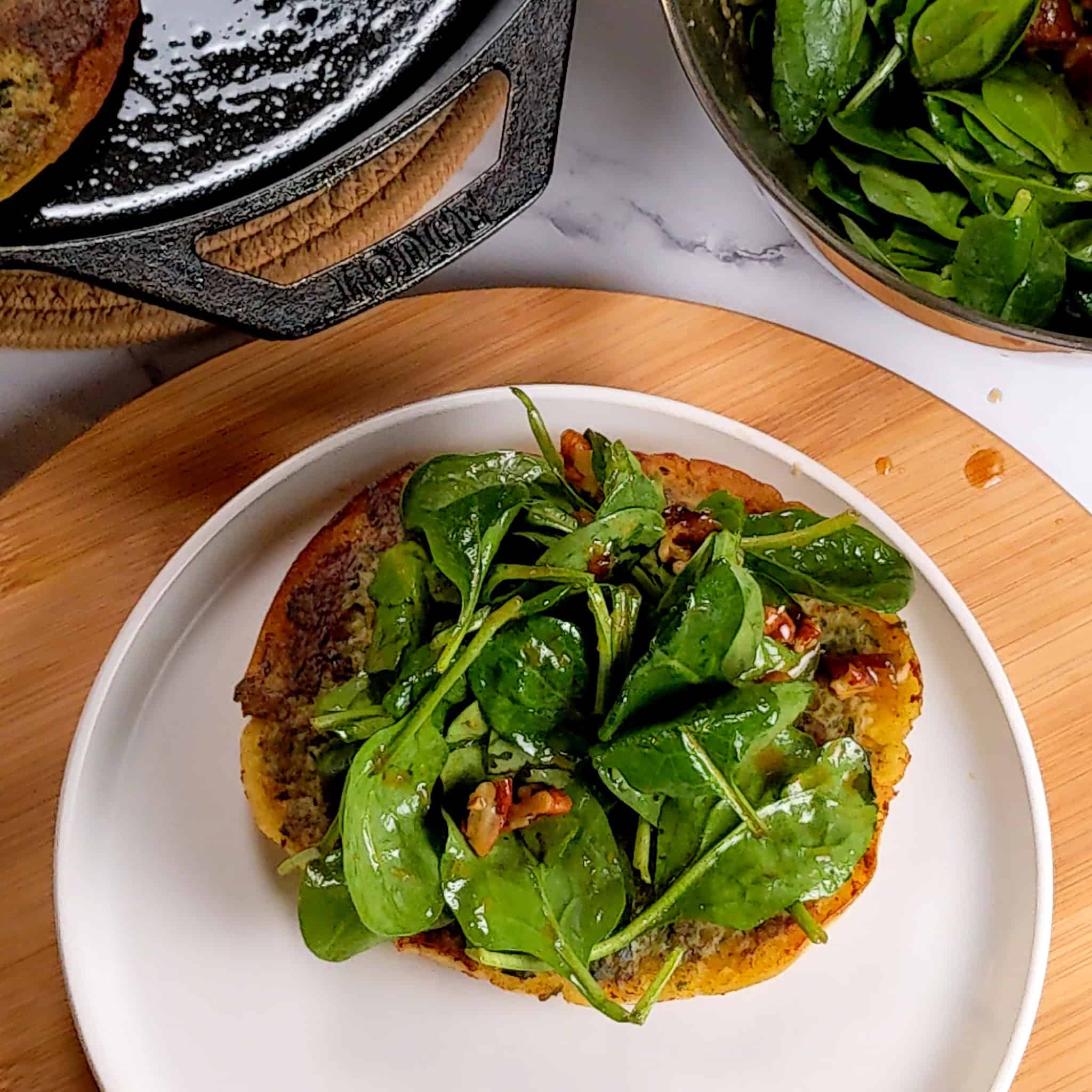 the first ground chicken pita topped with the spinach and date salad.