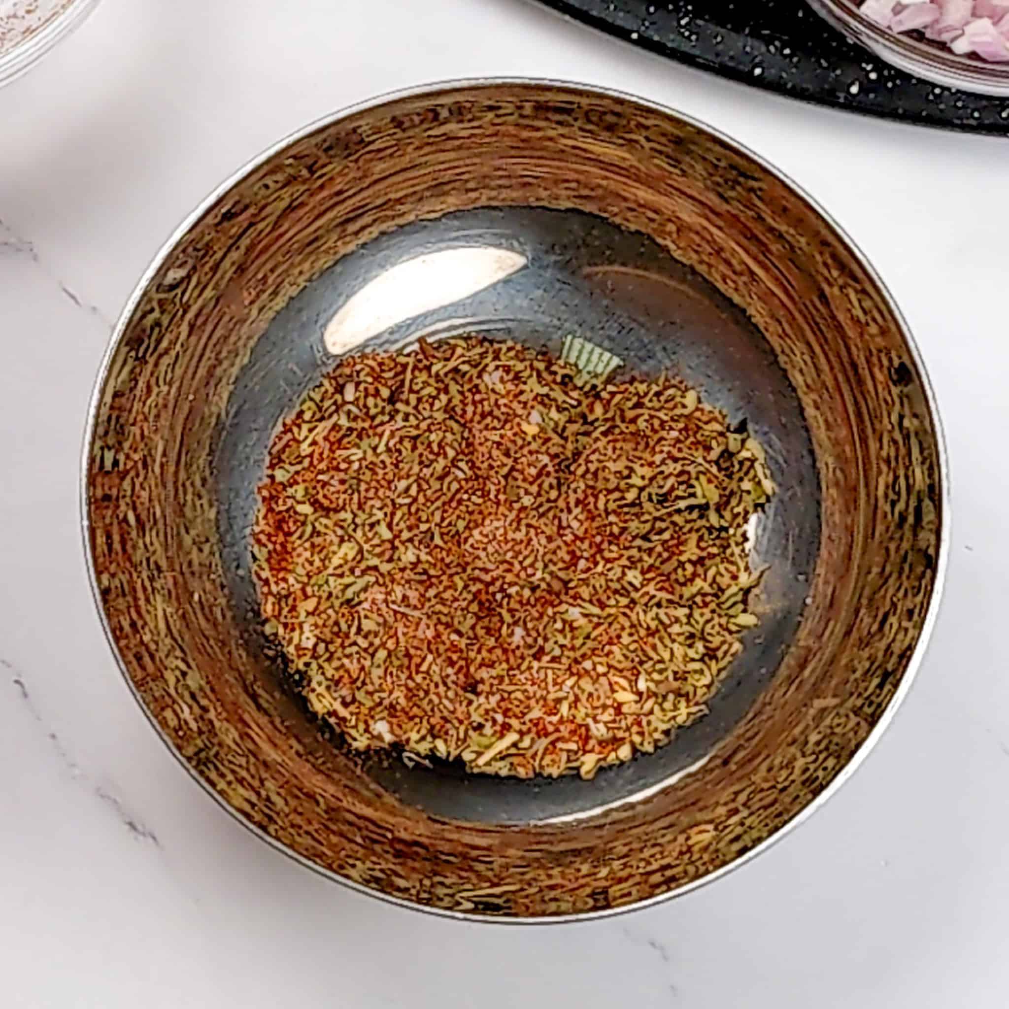 adobo seasoning for the Air Fryer Habanero Adobo Salmon and asparagus in a small stainless steel bowl.