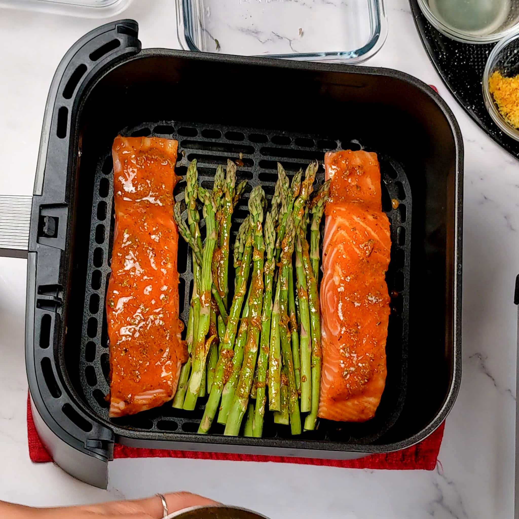 the cosori turbo blaze air fryer basket with the seasoned salmon and asparagus.