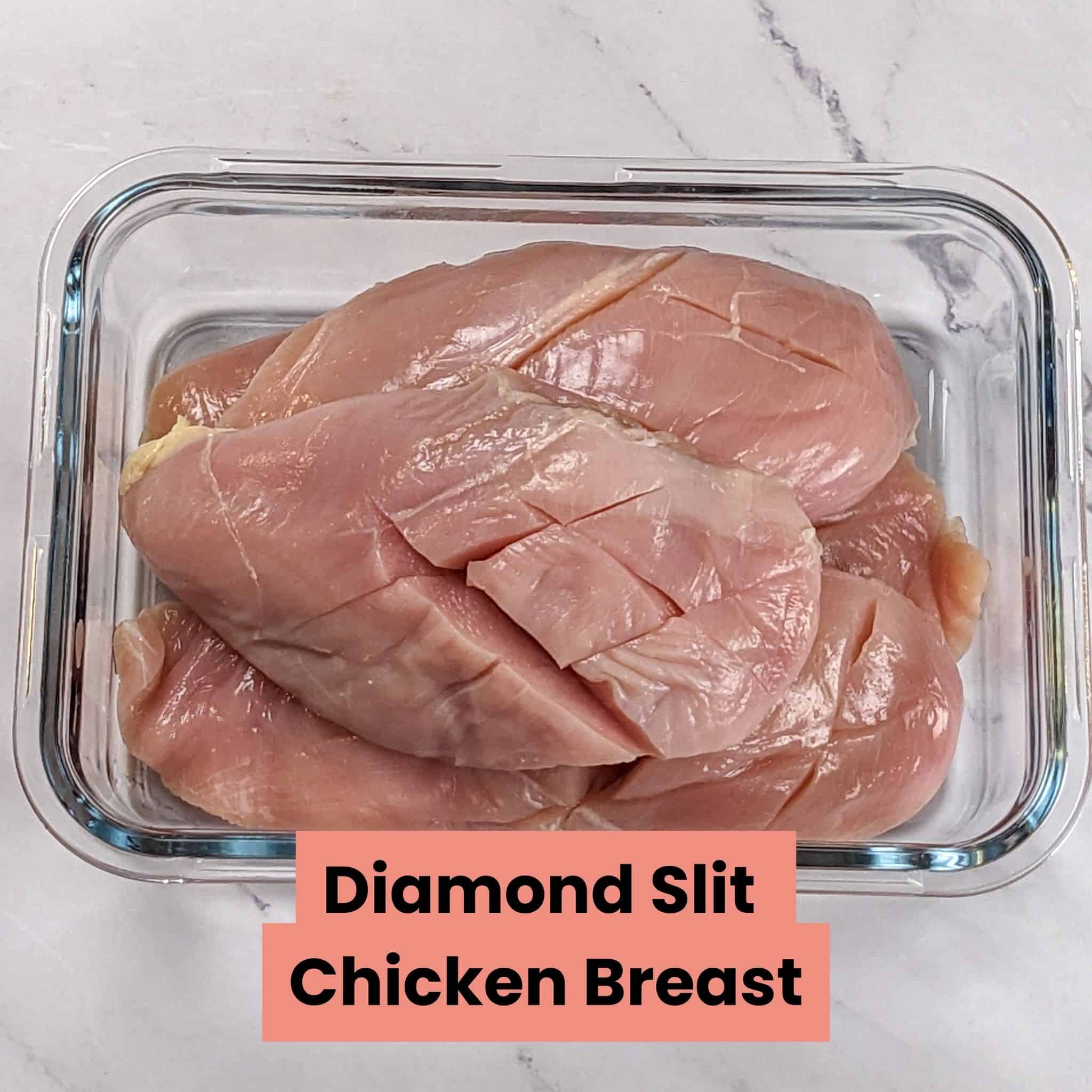 Raw diamond slit chicken breast in glass container.