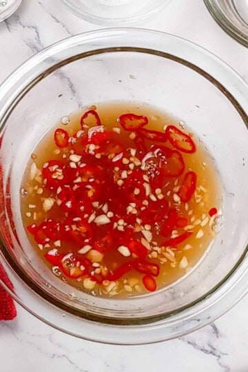 nouc cham sauce in a glass container.