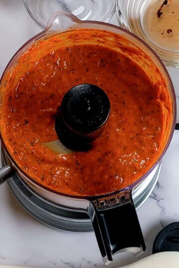 the finished spicy basil romesco sauce in the kitchenaid chopper.