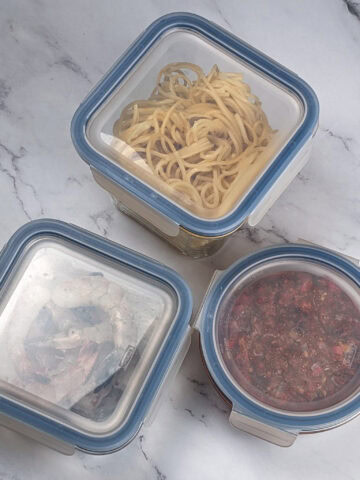 Leftovers in airtight glass containers with plastic clip-on lids.