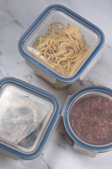 Leftovers in airtight glass containers with plastic clip-on lids.