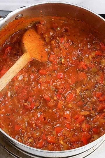 The tomato-based sauce cooks down.