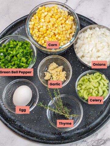 Fresh ingredients for chicken corn chowder dumplings: corn, peppers, onions, garlic, and herbs.