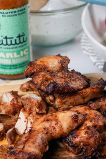 close up of the Beituti Shawarma Chicken Thighs sliced on a cutting board.