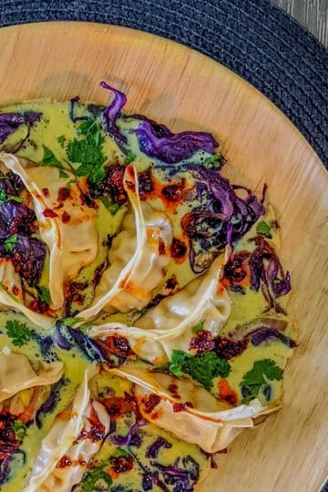 top view of the potsticker pinwheel pan-fried with cabbage, cilantro and eggs, and drizzled with chili oil sauce.