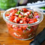 pico de gallo, fresh salsa in a glass container.