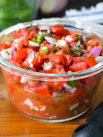 pico de gallo, fresh salsa in a glass container.