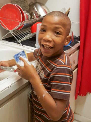 Jean (my son) in the kitchen helping out with washing the dishes.