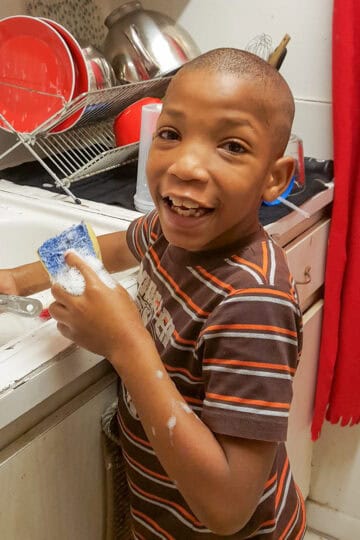 Jean (my son) in the kitchen helping out with washing the dishes.