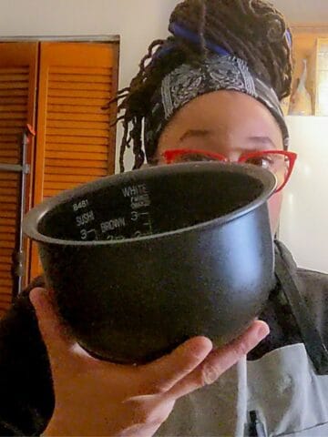 chef maika holding a rice canister for the rice cooker.