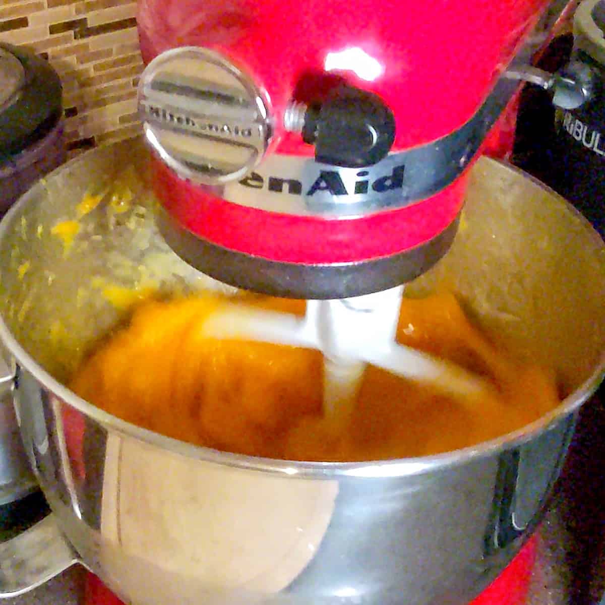 mango puree in a kitchenaid mixer with a paddle attachment.