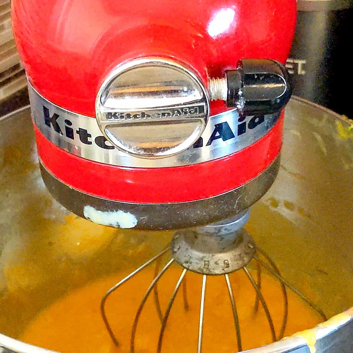 pureed mangoes in a kitchenaid mixer with whisk attachment.