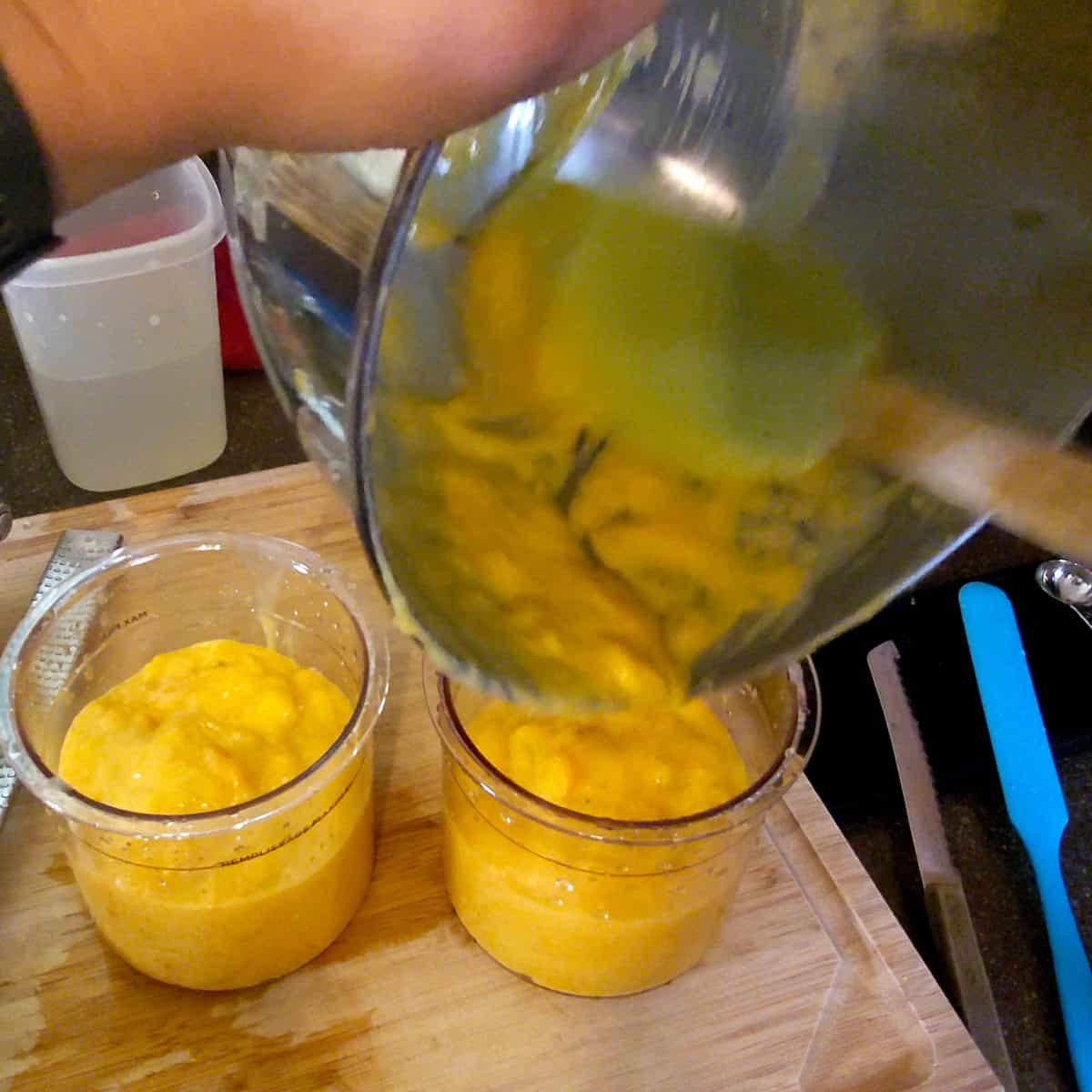 mango coconut felato gelato poured into two nanji creami containers.