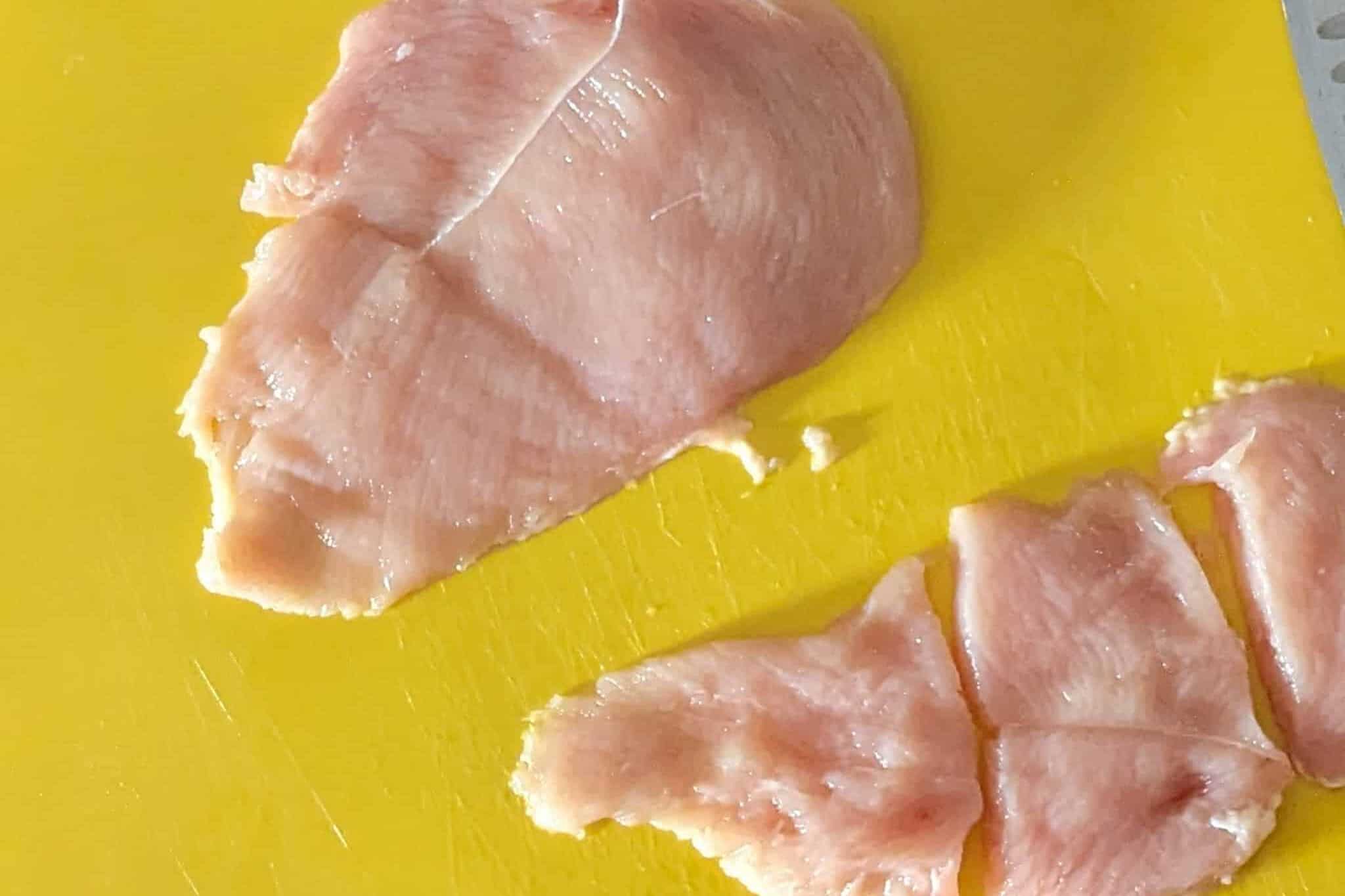 a butterflied chicken that has been divided into two with one half cut into thirds for small chicken cutlets