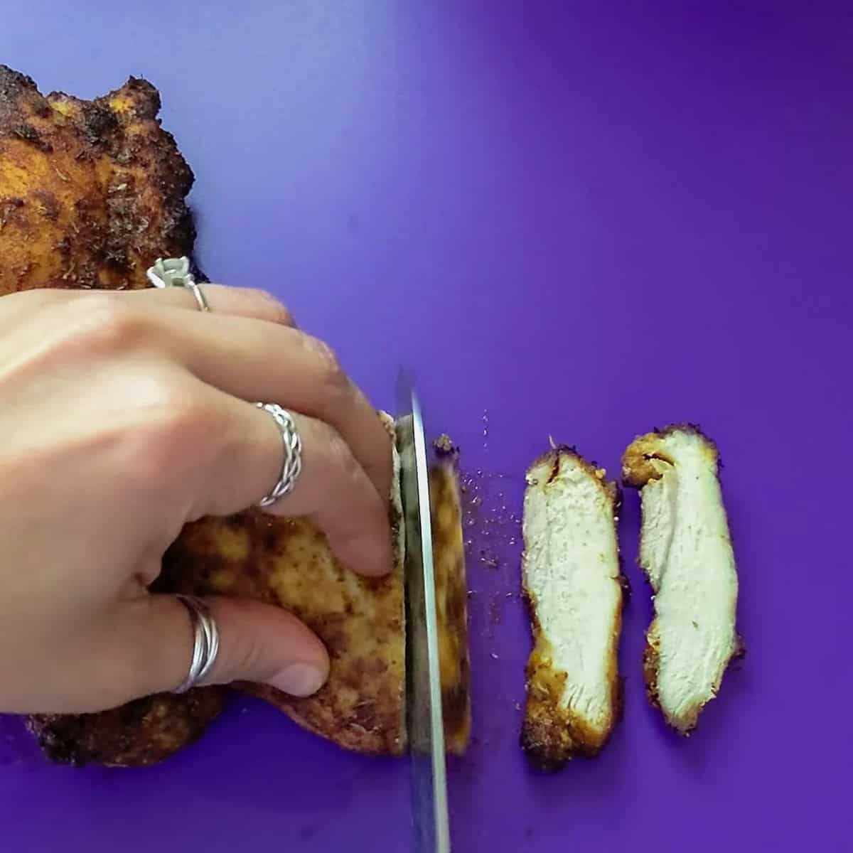 crispy air fryer chicken being sliced.
