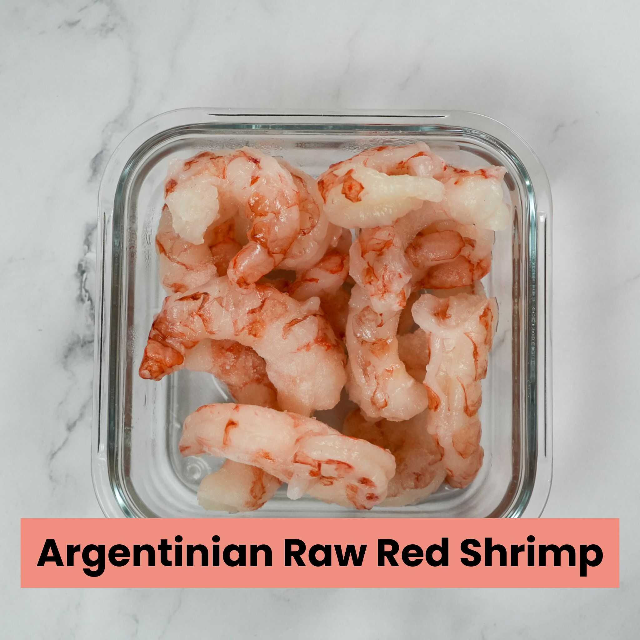 argentinian raw red shrimp in a glass container.