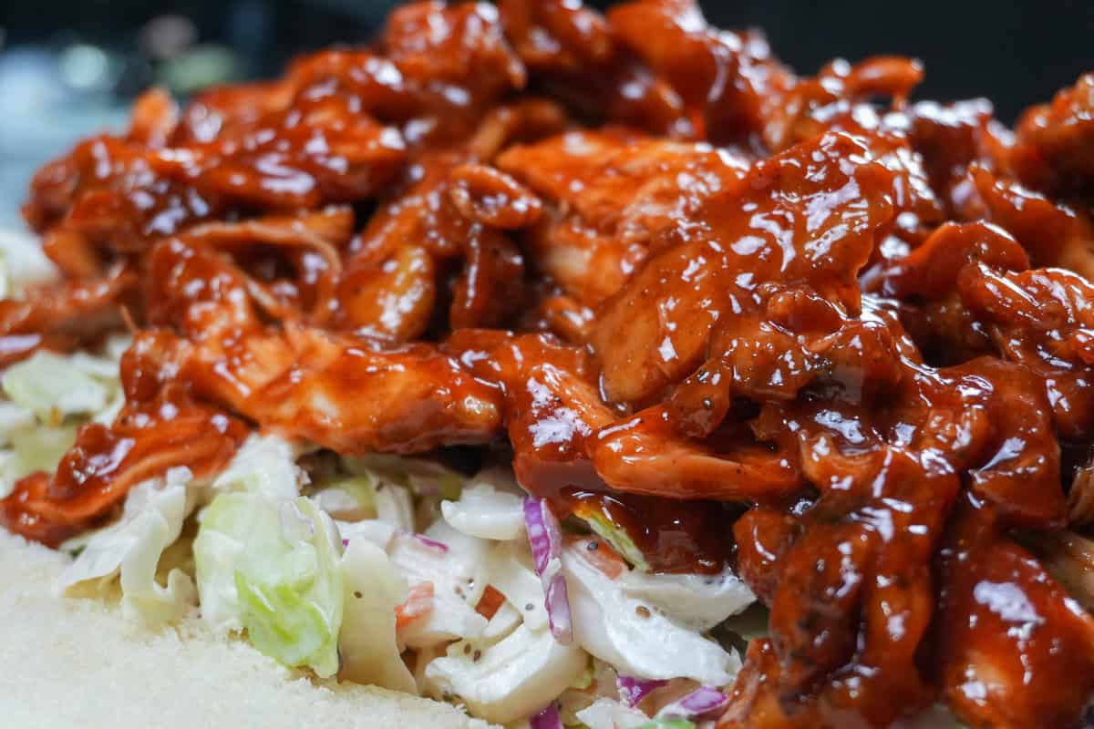 side close up of the bbq chicken sliders without the top bun.
