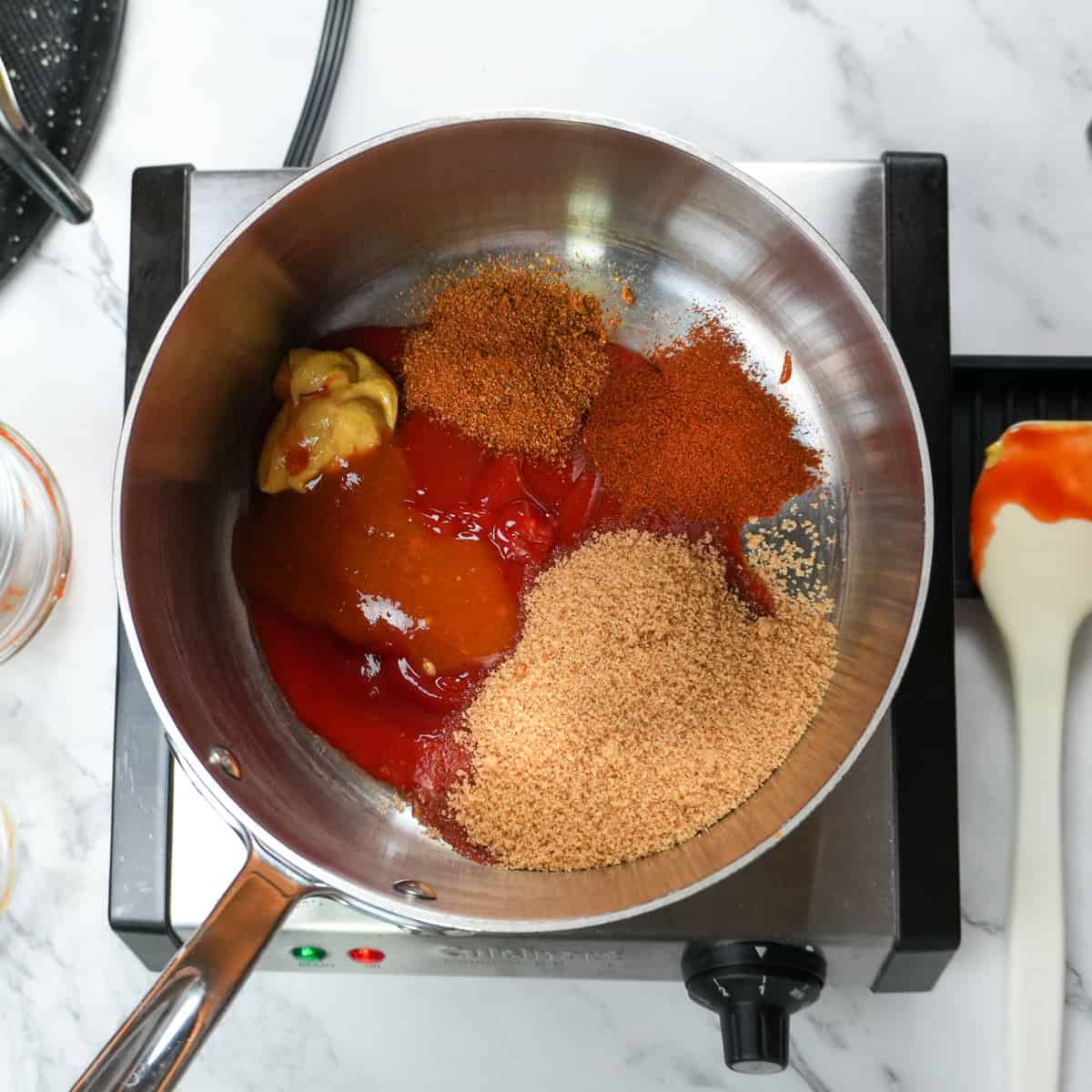 all ingredients for the bbq sauce added to a saucepan.