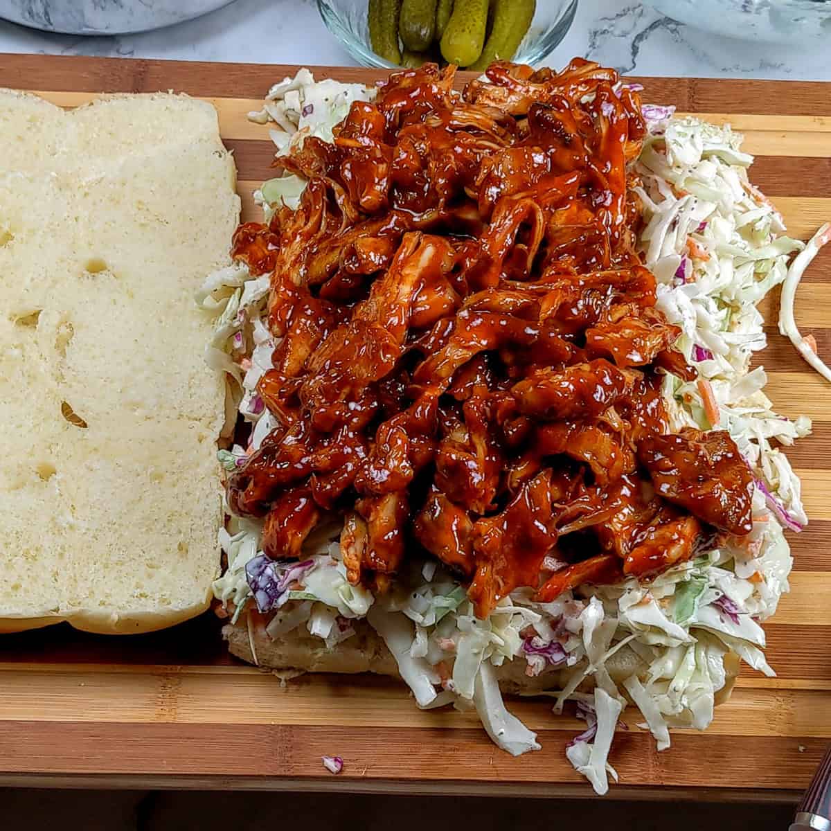 bbq shredded chicken on coleslaw on hawaiian rolls.