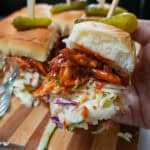 chef maika hand holding a bbq chicken slider.