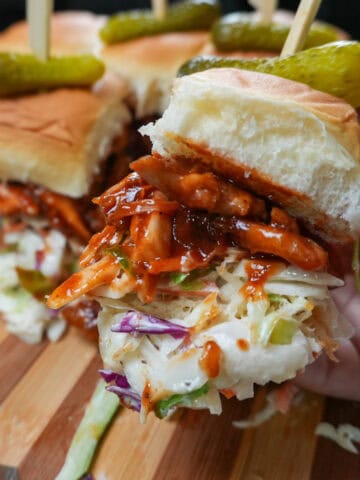 chef maika hand holding a bbq chicken slider.