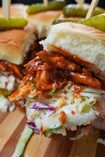 chef maika hand holding a bbq chicken slider.