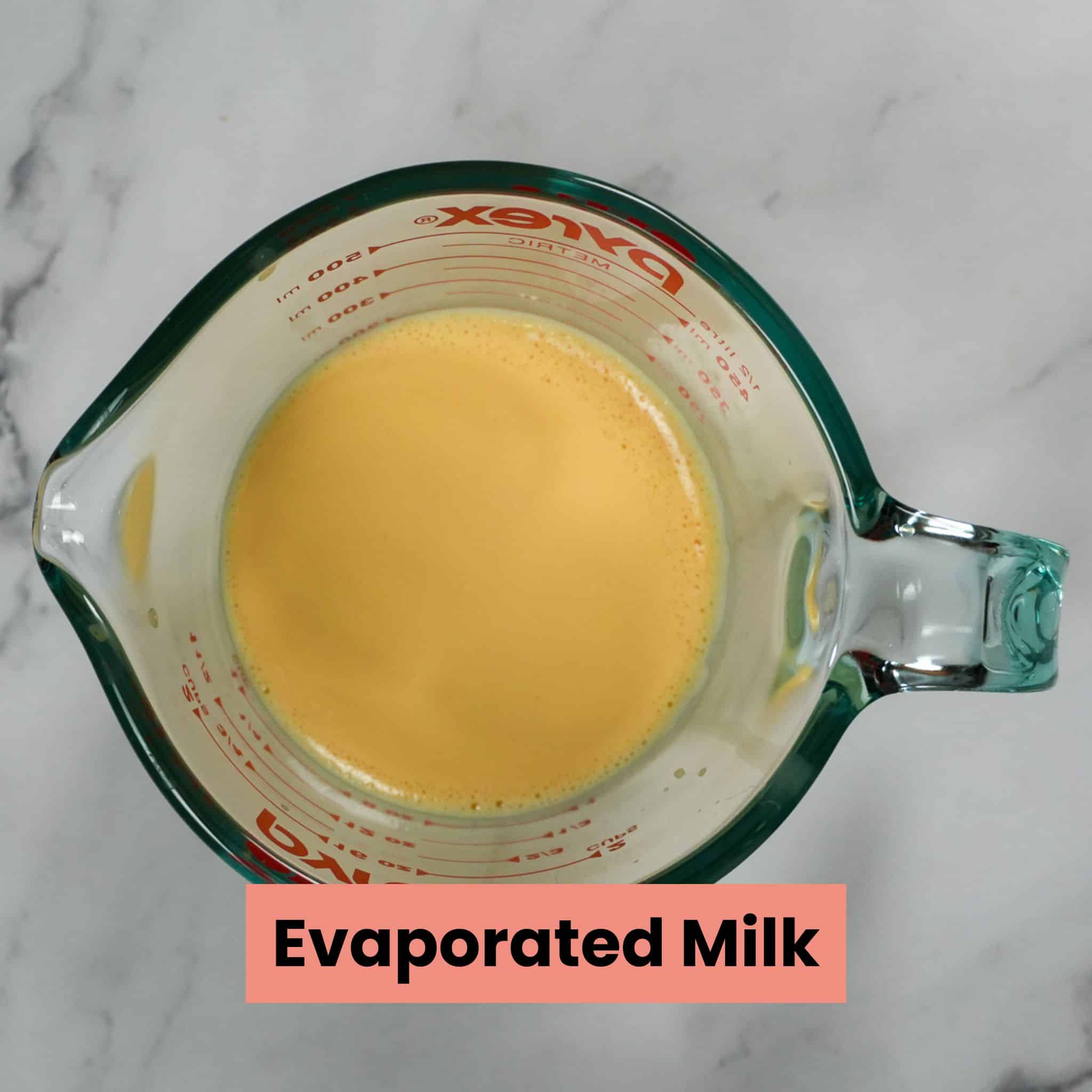 evaporated milk in a measuring cup.