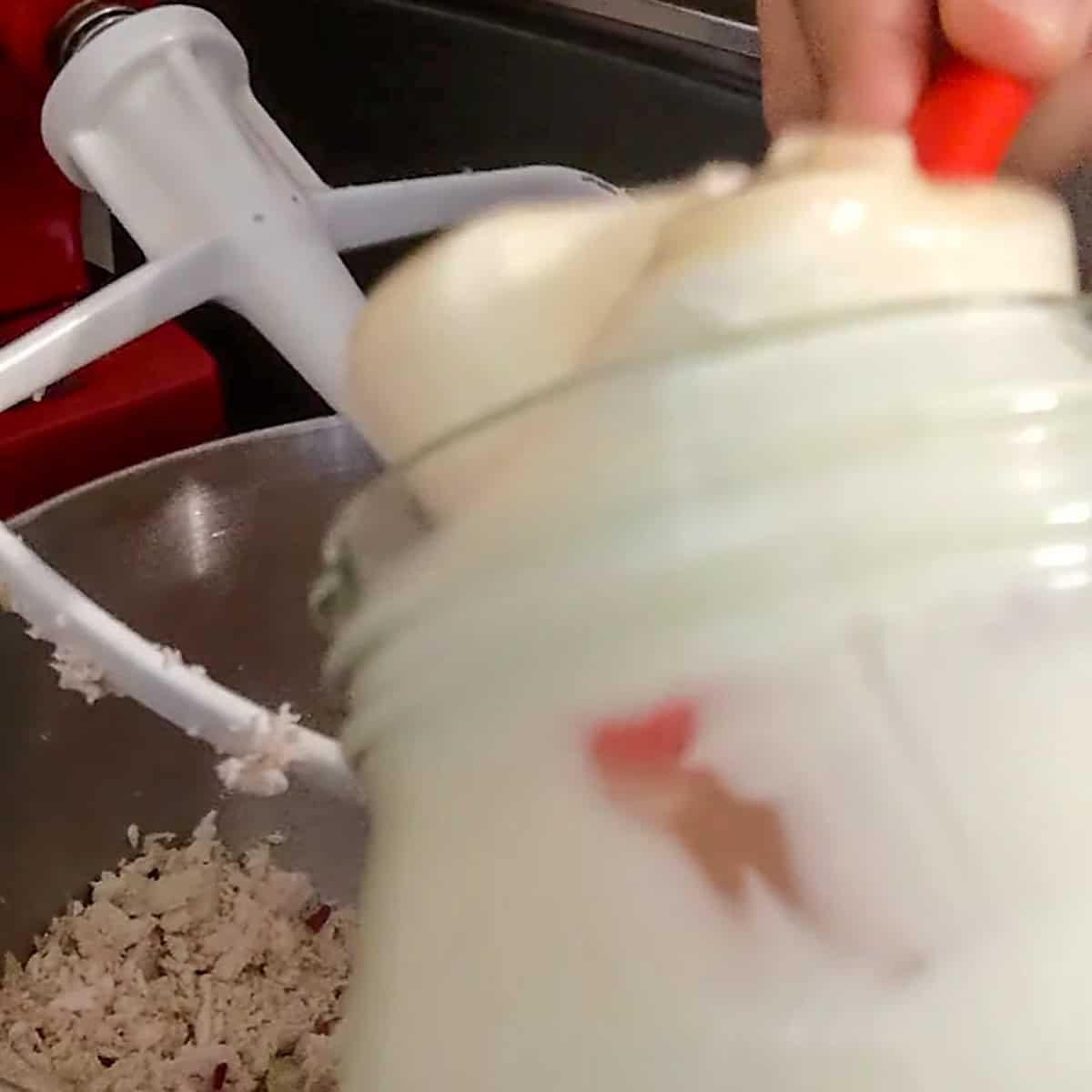 spoon mayonnaise out of it's glass jar into the stand mixer's bowl with the paddle attachment section tilted up.