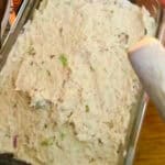 rectangle glass food storage container packed and evenly spread out freshly made chicken salad.
