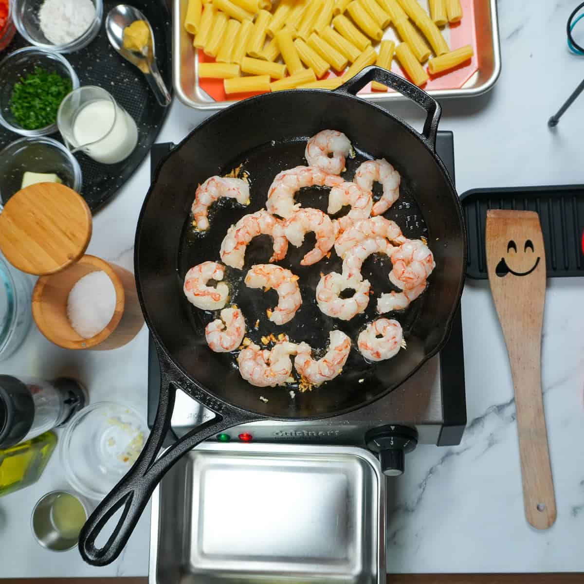 searing shrimp in a skillet.