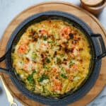 Broiled haitian style shrimp mac and cheese in a lodge cast iron blackock skillet.