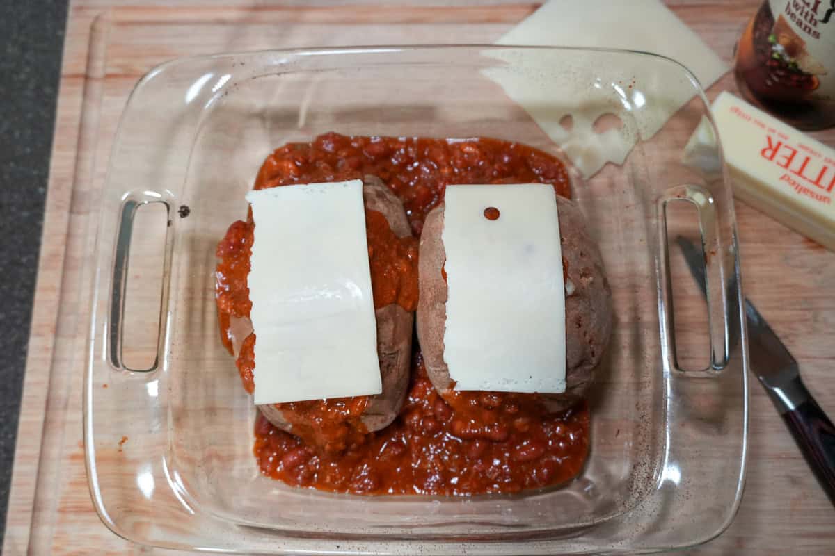 turkey chili and baked potatoes topped with sliced swiss cheese.