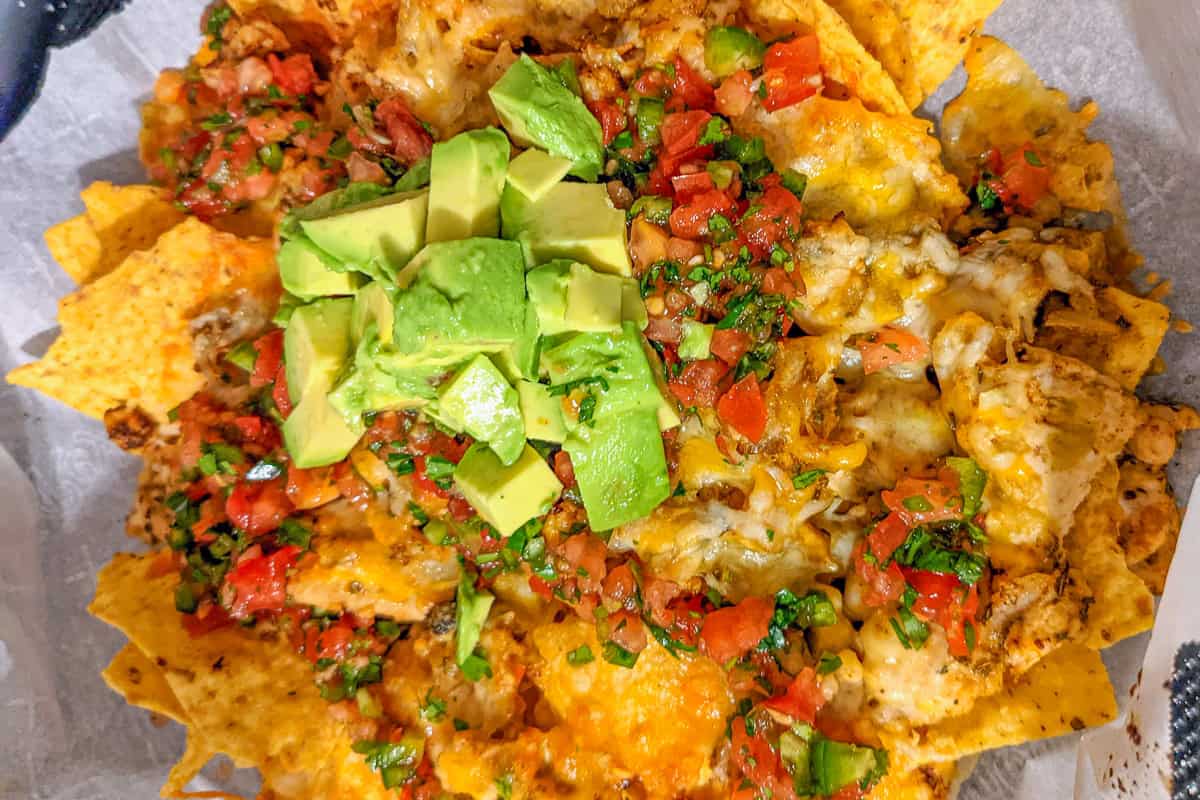 ripe avocado chunks on nachos.