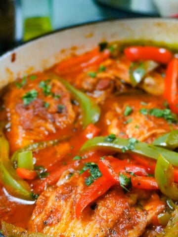close up of the Mexican Braised Chicken dish in an lodge cast iron enameled dutch oven.