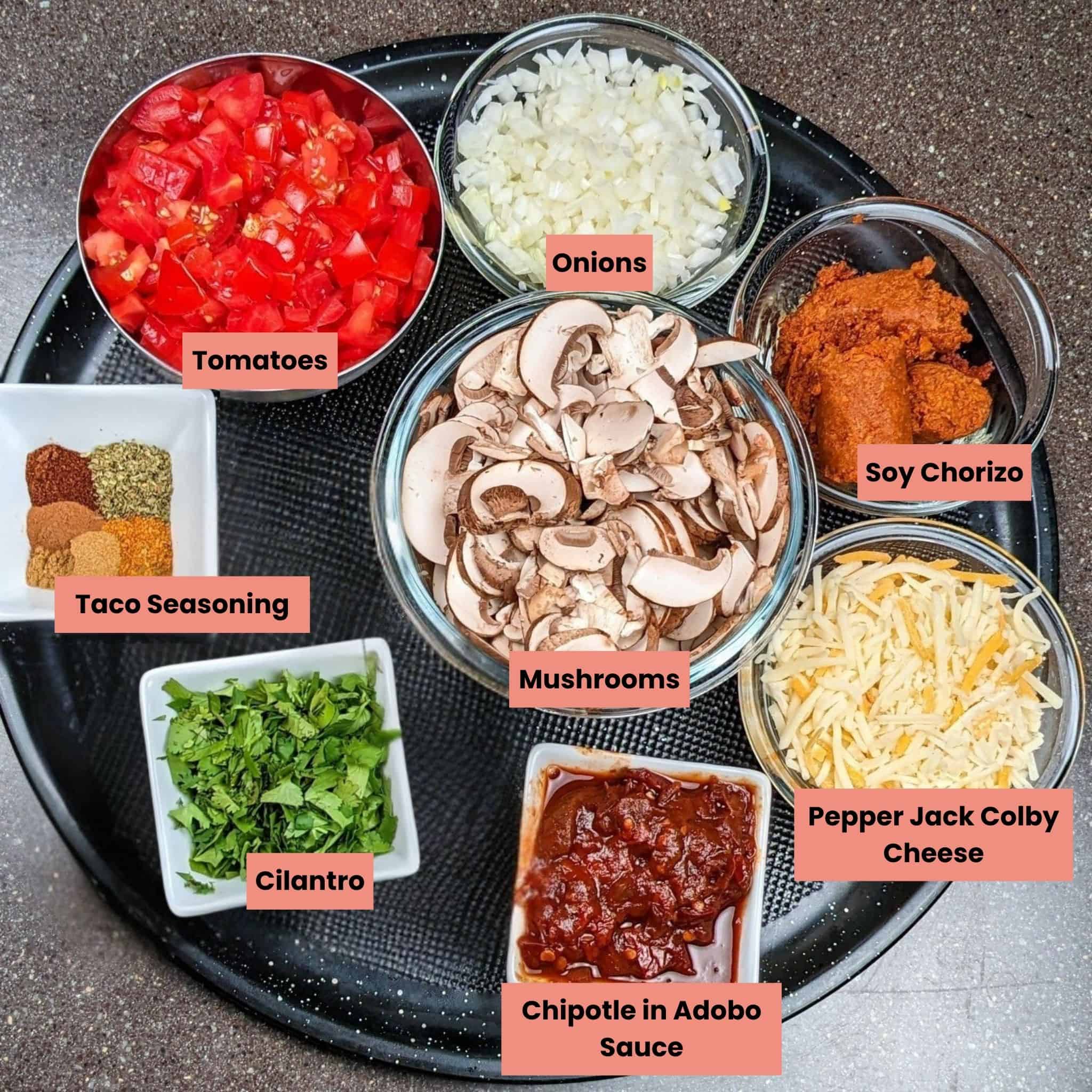 ingredients for the Protein-Packed Loaded Vegetarian Nachos Recipe in containers on a round tray.
