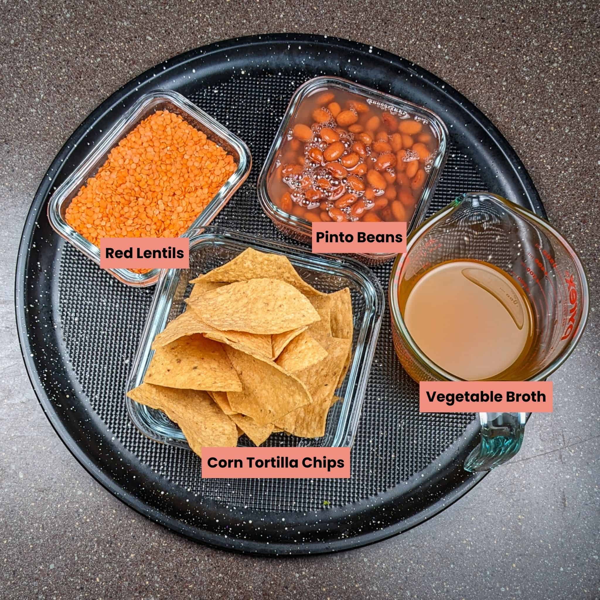 more ingredients for the Protein-Packed Loaded Vegetarian Nachos Recipe in containers on a round tray.