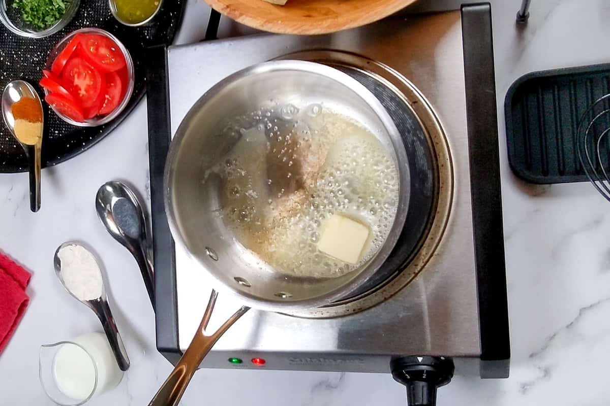 slab of butter melting in sauce pan.